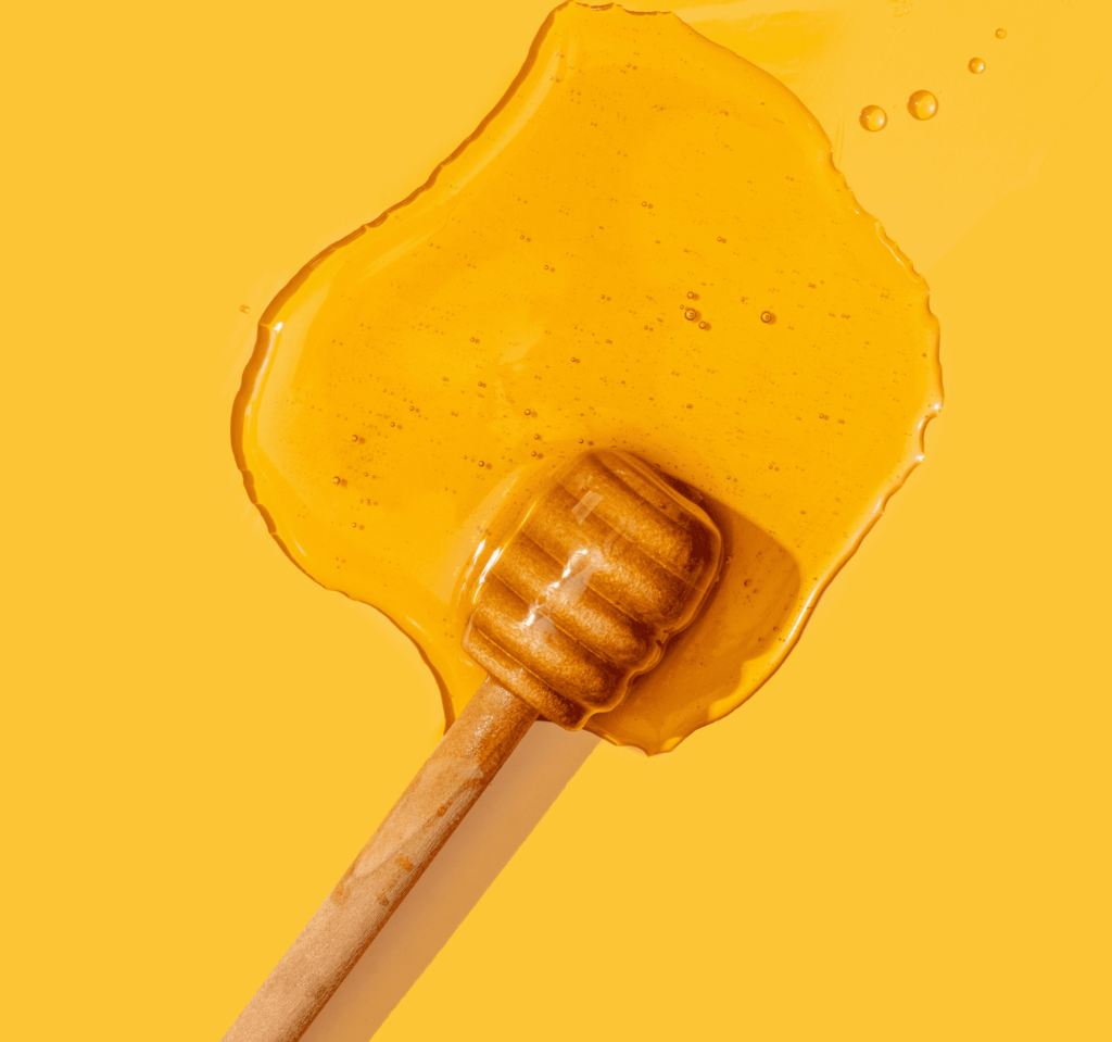 A wooden stick is pored in Honey